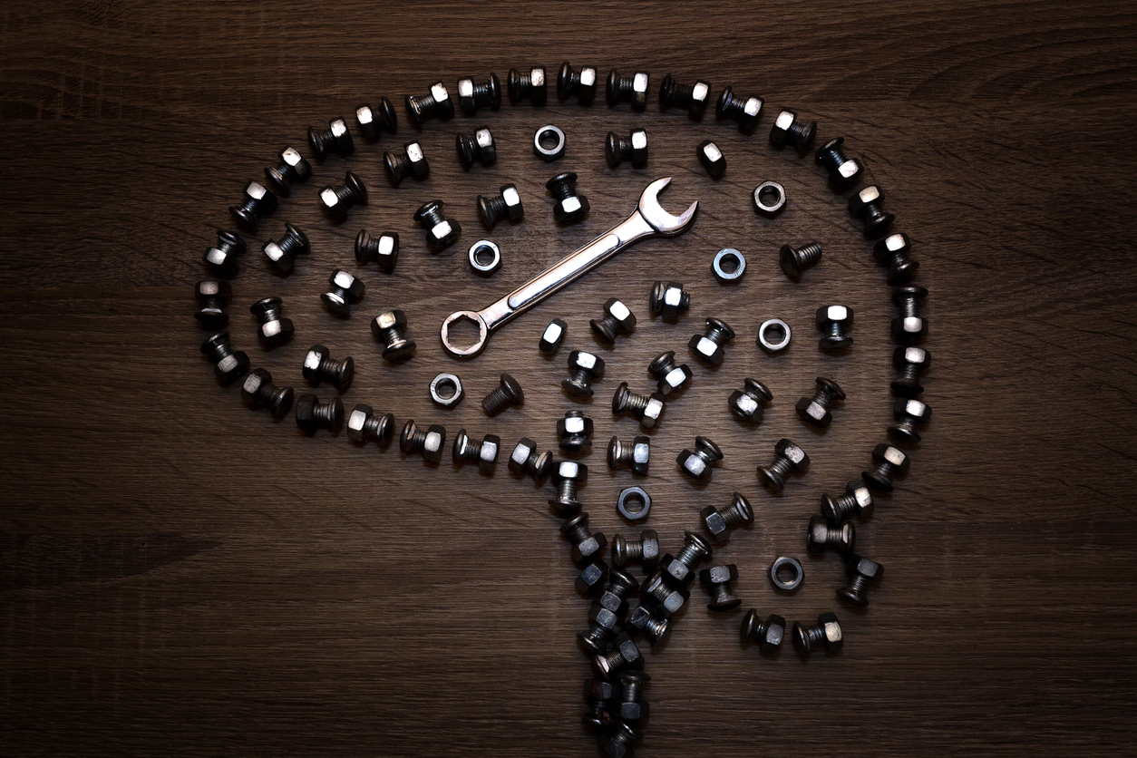 Thinking Brain made of tools, nuts and screws on wooden background