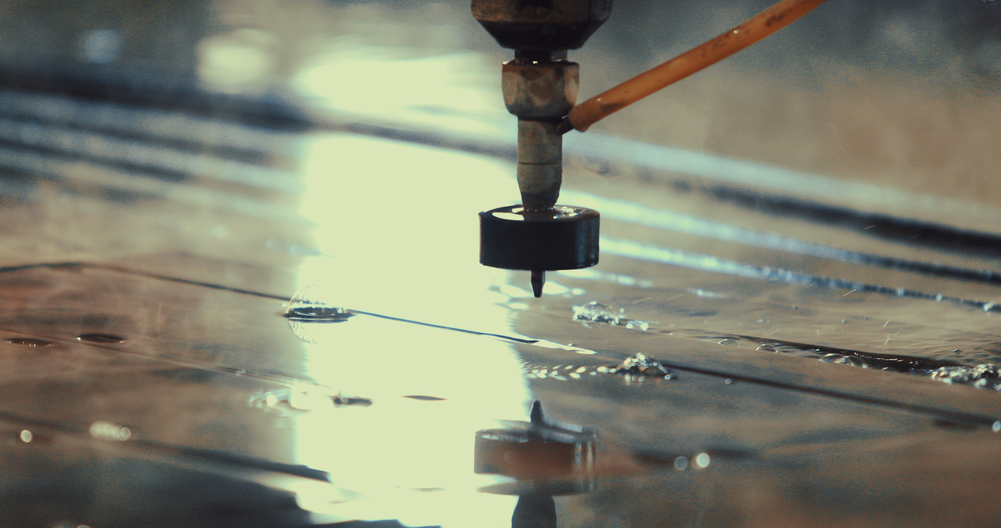 Depicting a metal cutting water jet machine from a close distance.